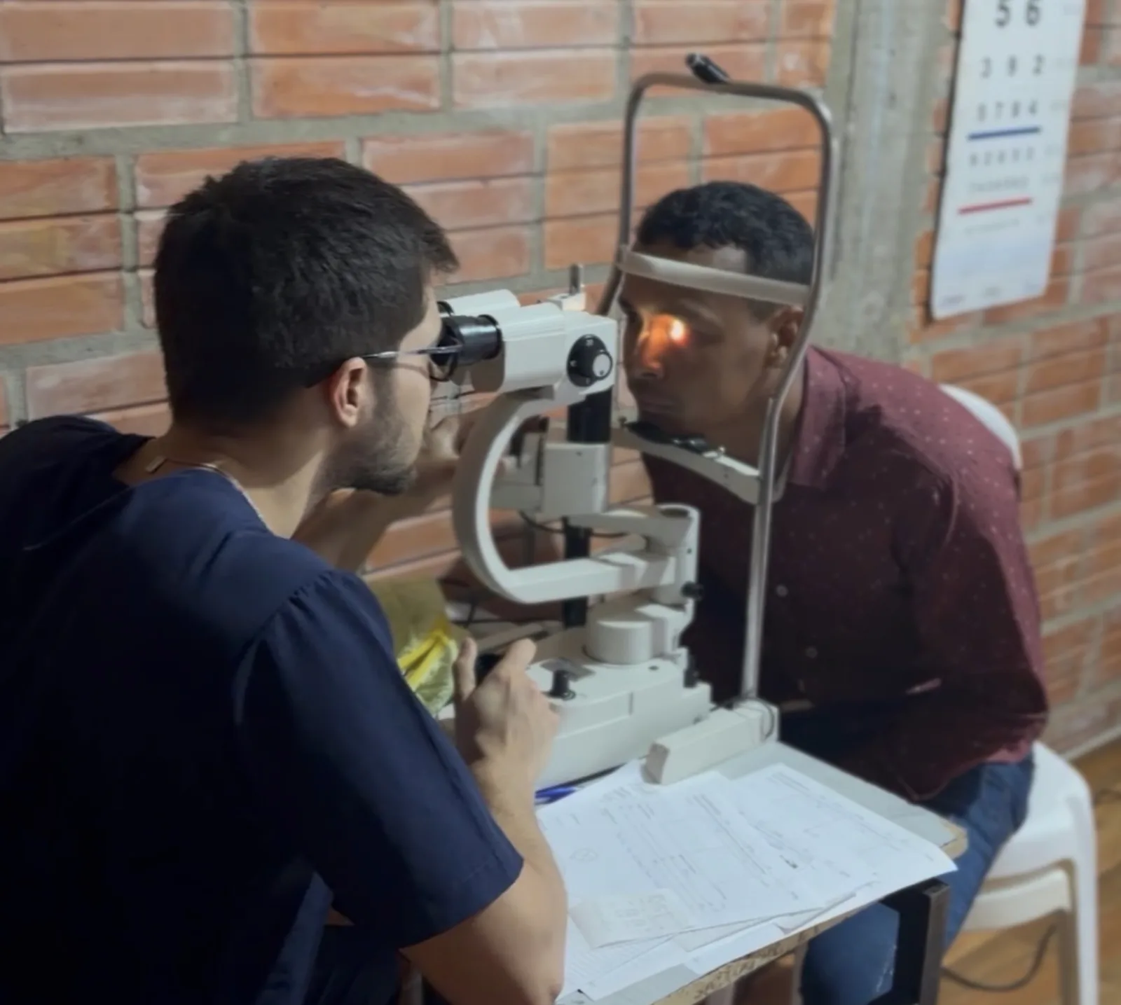 A clinician conducting an eye examination during a community clinic