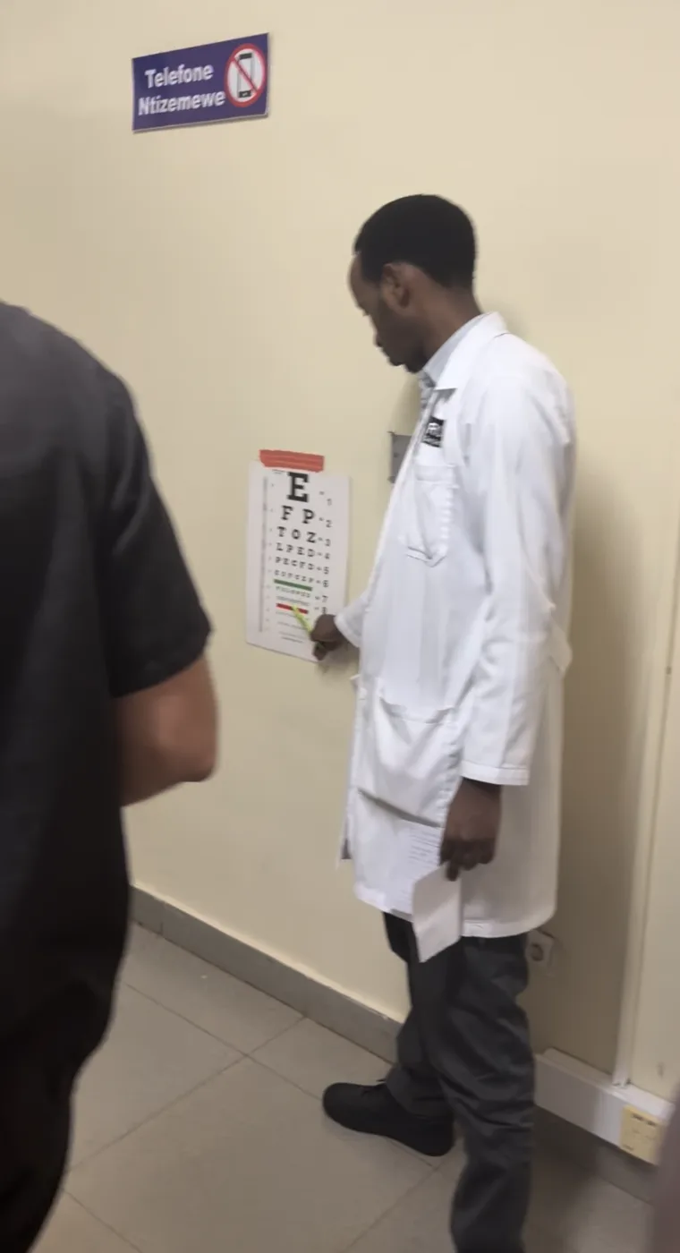 A clinician conducting a vision assessment in Rwanda